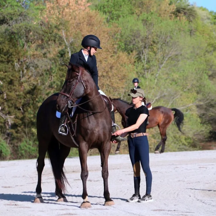 Rider and instructor working together over fences